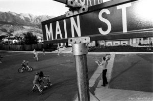Kids playing in suburban main street with Mt. Timpanogos in background. 