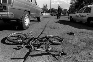 13-year-old boy was killed when truck hit his bike. He was knocked out of his shoes, which landed 30 feet apart. Daily Herald: An 11-year-old Orem boy was listed in critical condition this morning after he collided head-on with a jeep while riding his bicycle late Monday afternoon. Christopher J. Redd, 420 S 560 E., suffered multiple fractures and remains in the intensive care unit of the Utah Valley Regional Medical Center today. He underwent surgery at the hospital last night following the 5:#0 pm accident that occurred at 1385 S. Carterville Road. According to a report filed by Officer Leonard Brown, Redd was traveling east on 