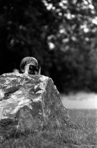 Kid watching out with binoculars while playing with guns outside our apartment. Two kids playing with guns outside our apartment.  Erik Finn, 8