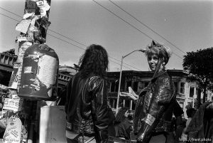 Leather-glad girl in front of the burned remains of a Thrifty Jr. store under construction in the Haight-Ashbury District.