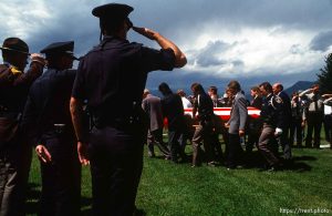 The body of a firefighter killed in the Midway Fire, 1990, is carried to the gravesite.