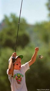 Kid catches a bluegill while fishing at the Lafayette Reservoir