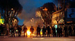 Police line and fires during riots and protests.