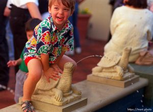 Kid playing on fountain