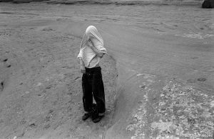 AQ taking his shirt off at Arches National Park