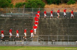 Campolindo football players walk the bleachers at practice