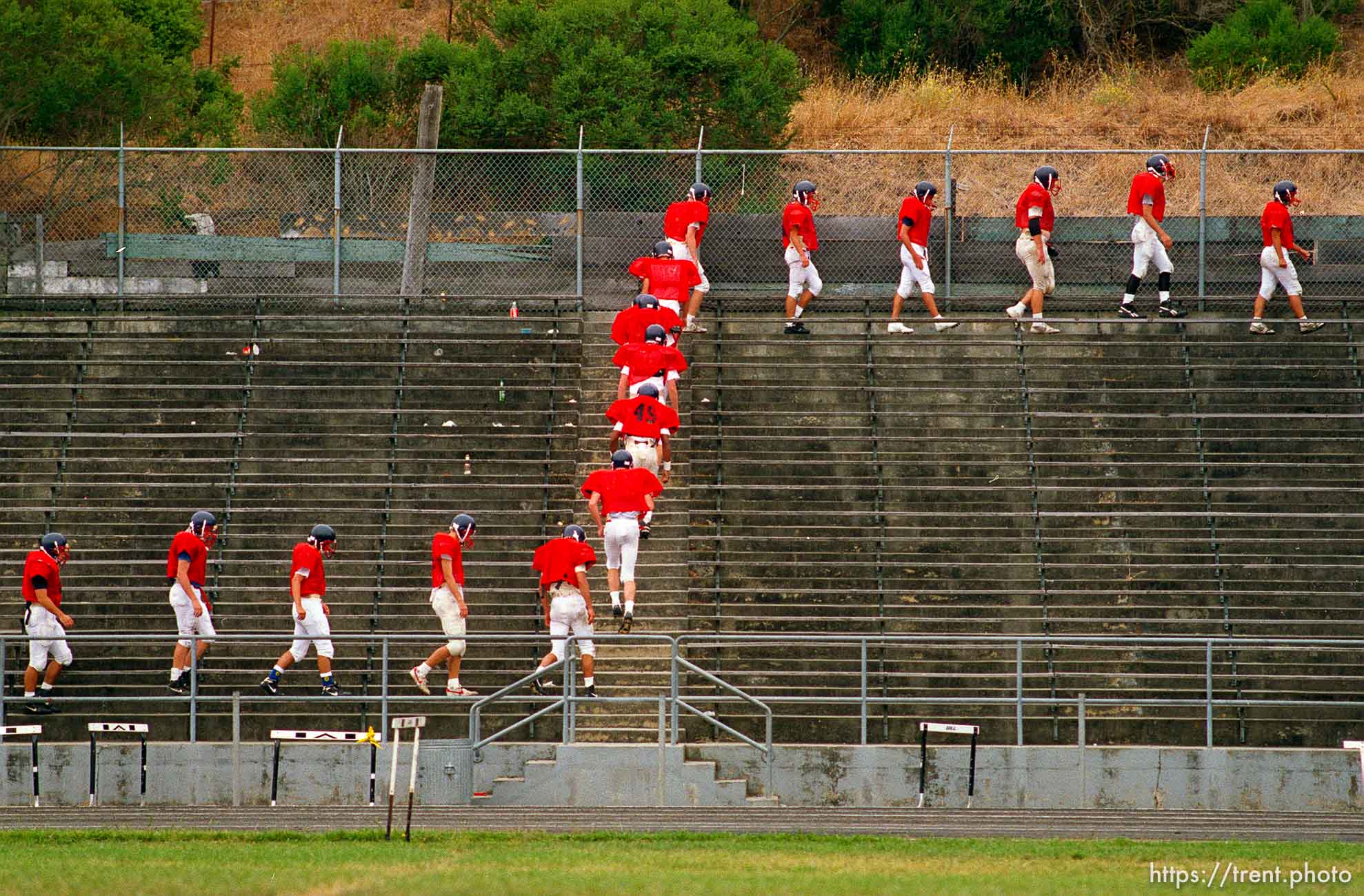 Campolindo football players walk the bleachers at practice