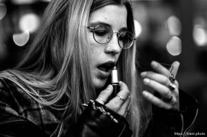 Girl puts on lipstick