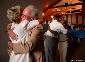 People hug at Unity Church service
