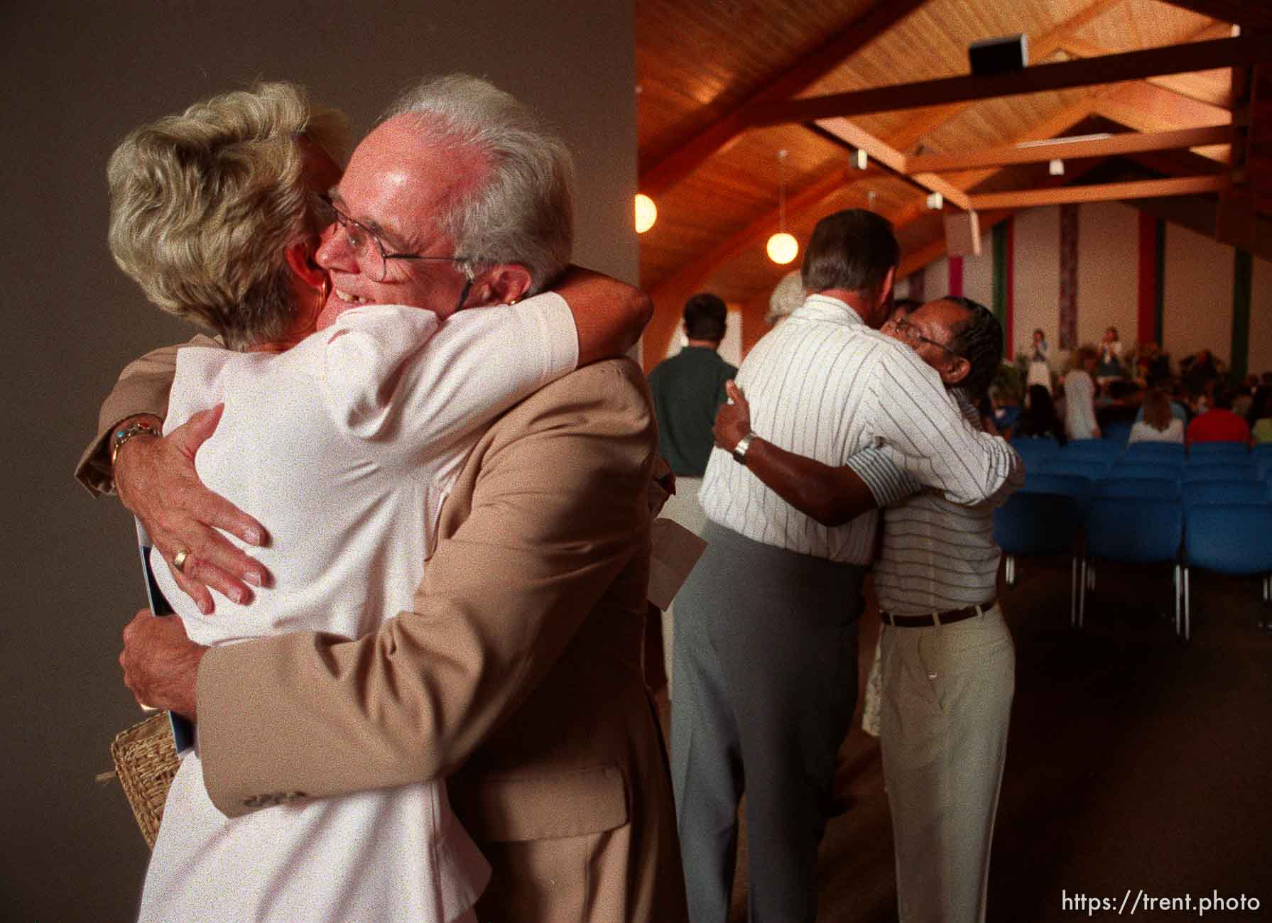 People hug at Unity Church service