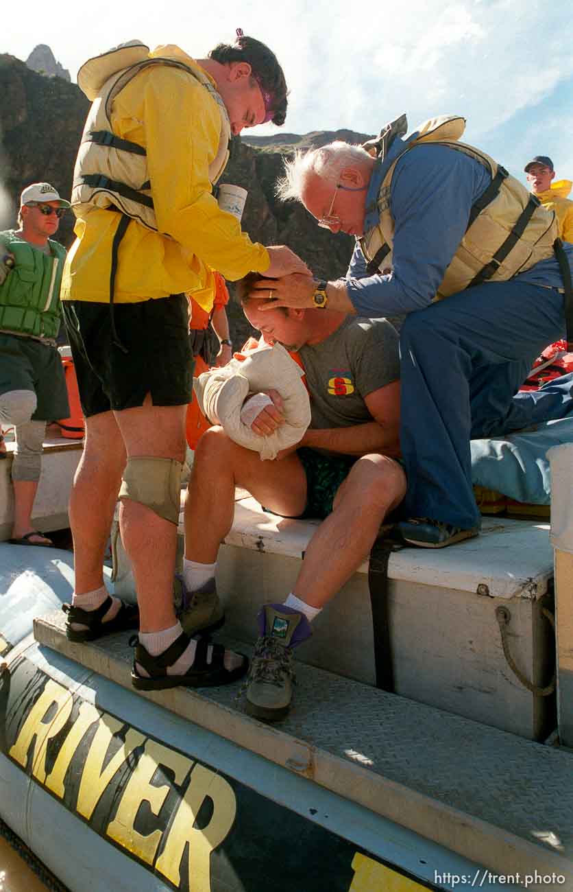 John and Dick give Steve an LDS priesthood blessing after he hyper-extended his elbow in Crystal Rapid. Grand Canyon flood trip.