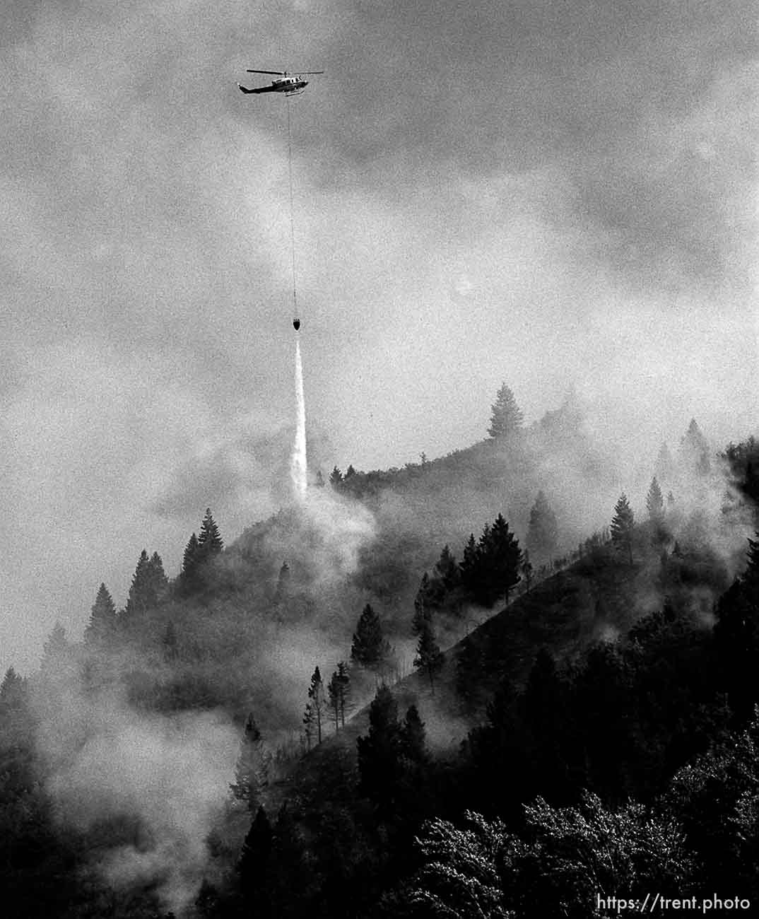 A fire-fighting helicopter dumps water on a fire in the South Fork area of Provo Canyon. photo by trent nelson