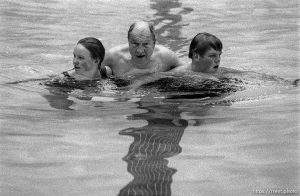 Roy Stones (center) walks laps in the pool at the Deseret Gym with his grandchildren Nicole and Jacob Stones. Roy has been a member of the Gym 