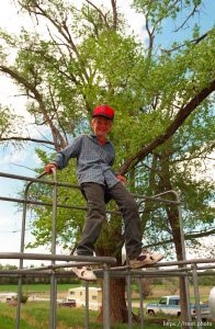 Kevin Sherman, 8, on the bars at a school playground.
