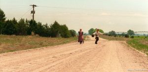 Shalisse Lewis, SLC, and Joseph Johnston (goofing off, posing) on the Mormon Trail Wagon Train.