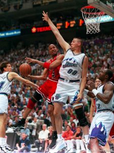 Chicago's Ron Harper tries to shoot over Utah's Greg Ostertag at the NBA Finals Game four, Utah Jazz vs Chicago Bulls.