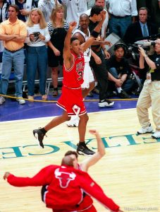 Scottie Pippen celebrates NBA Championship while Bryon Russell walks off court at Jazz vs. Bulls, game 6 of the NBA Finals. Bulls won