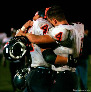 Brighton teammates Patrick O'Keefe and Lawrence Cowan embrace following their last game of the season at Brighton vs. Davis football playoffs game. Davis won.
