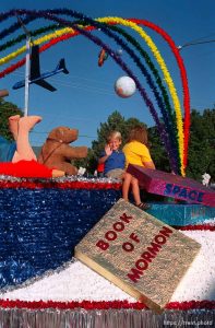 5-year-old Bradley Snelgrove waves from the Woods Cross Stake float in the Bountiful Hand-Cart Festival Parade