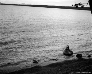Woman reading on shore of Yellowstone Lake