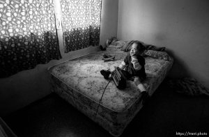 Doris on the bed, listening to the radio. Formerly conjoined twins, Bessy and Doris Gonzales.