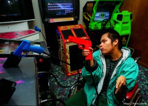 Disabled kids bowling and playing videogames.