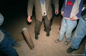 Family with an artillery shell casing at traditional dinner with the Hoxha family.