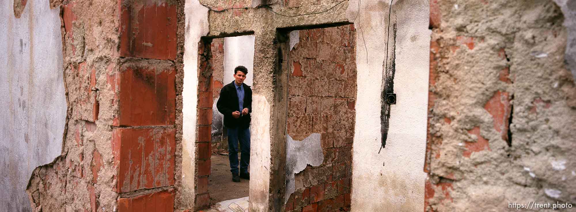 Anton Selitaj in what's left of his room in the family home, which was burned by Serbs.