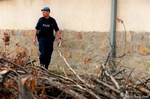 UNMIK police officer Zane Smith walking through a hillside village in Northern Kosovo