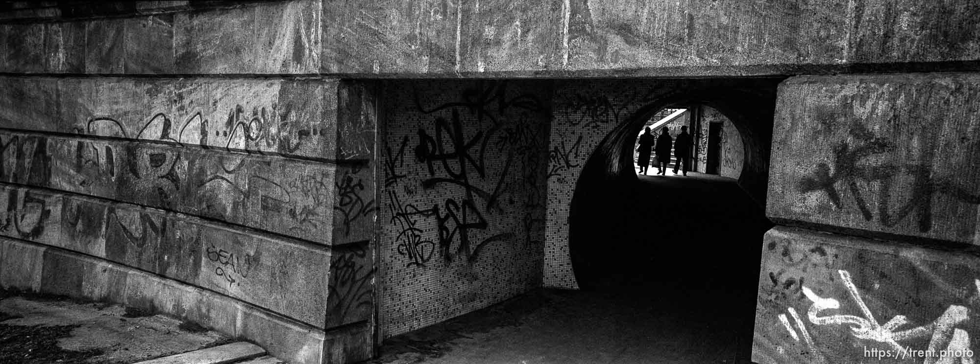 Pedestrians, graffiti, tunnel