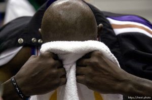 Olden Polynice puts his face in a towel at the end of Utah Jazz vs. Portland Trailblazers. Game 3, 2nd round NBA Playoffs. Trailblazers won to take 3-0 advantage in series, which they eventually won.