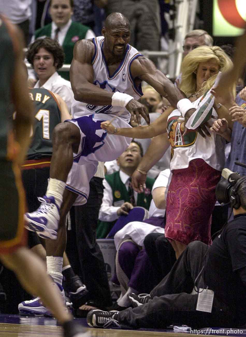 Karl Malone collides with colorful Sonics fan Brina Sanft at Jazz vs. Sonics, game 5, 1st round NBA playoffs. Jazz won.