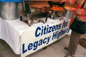 A woman who supports the Legacy Highways serves herself a hot dog at a public comment meeting on the proposed Legacy Parkway, or Legacy Highway.
