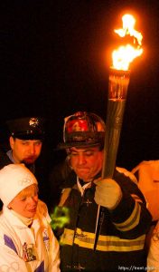The Olympic Torch commemorates victims and heroes of the World Trade Center attack on a boat near the Statue of Liberty, then proceeds to Rockefeller Plaza where Mayor Giuliani carried the final torch and lit the Olympic cauldron.  12.23.2001, 5:43:23 PM