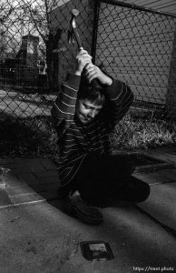 destroys a zip disk with a hammer. 