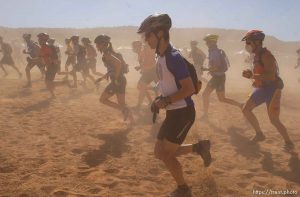It's a dusty Le Mans style start to the 24 Hours of Moab where racers run up and around a bush before getting on their bikes.