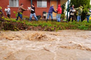 Volunteers work to save the Brigham City home of Linda and Arlin Kay as rain and melting snowpack raise the levels of Box Elder Creek and the Logan River. flood