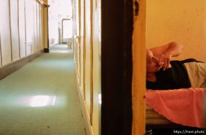 With the door to his room open for any extra breeze, Ronnie Mendez has a smoke in bed while watching the soap opera 