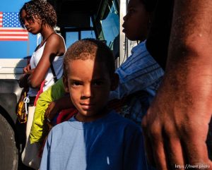 Frank Dalcour, Jr, waits to board a bus with his sisters, Tanaika Bettis (left) and Ricsyna Bettis (right) and parents (not shown). About 100 of the 600 or so evacuees housed at Camp Williams boarded buses to Dallas, Texas Wednesday evening. From Dallas, they will make they way to a variety of locations and reunite with friends and family members.