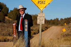 Kane County Commissioner Mark Habbeshaw at the intersection of Johnson Canyon Road and Skutumpah Road in the Grand Staircase National Monument, where the BLM and Kane County have placed conflicting signs. Kane County's sign (on left) indicates OHV/ATV access, which the BLM disputes.