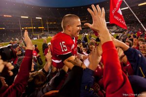 Utah quarterback Brett Ratliff is lifted up by fans after the win. University of Utah vs. Georgia Tech, Emerald Bowl, San Francisco.