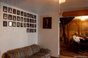 Marvin Wyler in his home with portraits of his 34 children