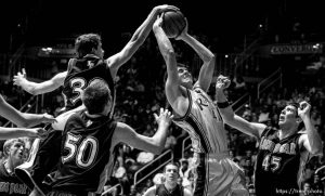 Ogden - Riverton's Brad Kraft tries to get a shot off surrounded by the entire Lone Peak team (left to right) Tyler Haws, Kevin Lindquist (50), Landon Clegg, Ryan Rios (5) and Bracken Funk (45). Kraft got the shot off and missed, while Lone Peak led by 18 at halftime. Lone Peak vs. Riverton High School boys basketball, 5A State Basketball Championship Game at the Dee Events Center Wednesday.