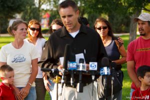 Huntington - Family members of miners missing in the Crandall Canyon coal mine stand with spokesman Sonny Olsen as he reads their statement to the media in the Huntington City Park. The family members wished to remain unidentified. ; 8.23.2007