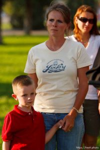 Huntington - Family members of miners missing in the Crandall Canyon coal mine stand with spokesman Sonny Olsen as he reads their statement to the media in the Huntington City Park. The family members wished to remain unidentified. ; 8.23.2007