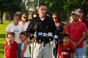 Huntington - Family members of miners missing in the Crandall Canyon coal mine stand with spokesman Sonny Olsen as he reads their statement to the media in the Huntington City Park. The family members wished to remain unidentified. ; 8.23.2007