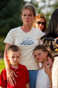 Huntington - Family members of miners missing in the Crandall Canyon coal mine stand with spokesman Sonny Olsen as he reads their statement to the media in the Huntington City Park. The family members wished to remain unidentified. ; 8.23.2007