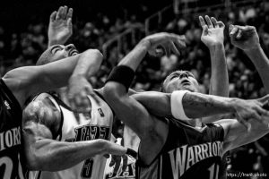 Salt Lake City - Utah Jazz forward Carlos Boozer (5) looks for the rebound with Golden State Warriors center Patrick O'Bryant (26) and Golden State Warriors forward Andris Biedrins (15). Utah Jazz vs. Golden State Warriors, NBA basketball Saturday night at EnergySolutions Arena.