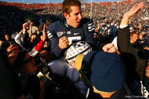 Provo - BYU fans hold Brigham Young quarterback Max Hall (15) on their shoulders, celebrating victory as BYU defeats the University of Utah 17-10 in college football action Saturday at BYU's Lavell Edward Stadium.