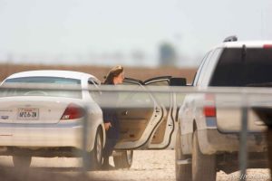 Eldorado - Young FLDS woman with baby arriving at civic center during raid on the FLDS YFZ 